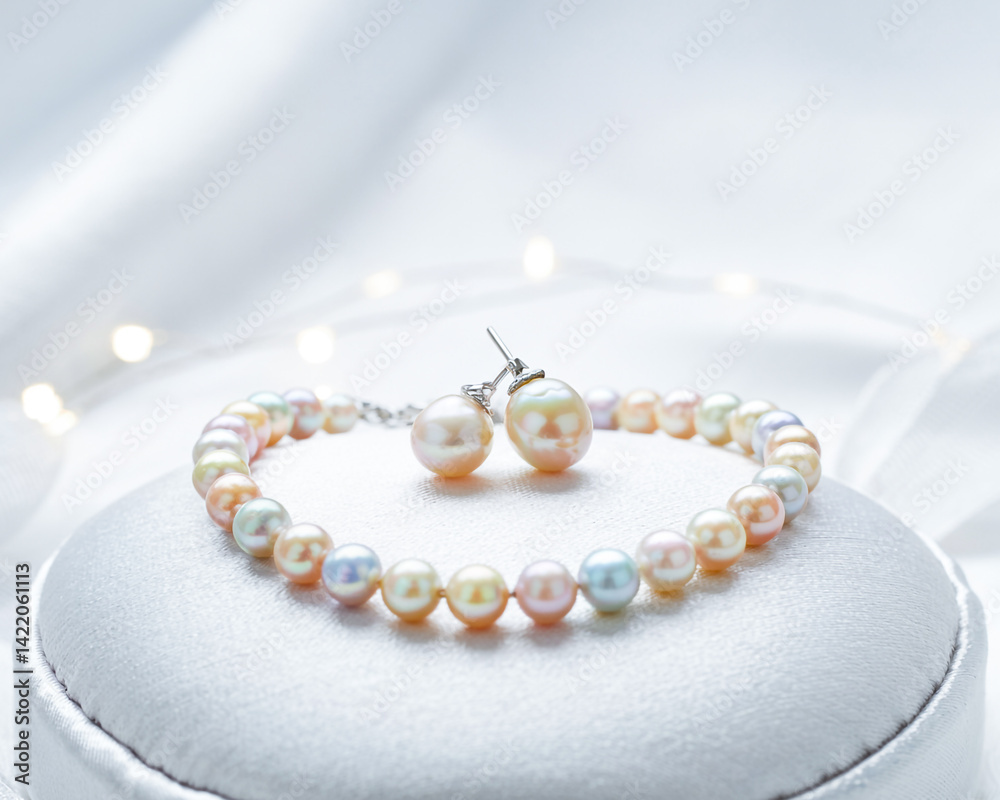 Elegant Pearl Jewelry Set Featuring Bracelet And Earrings On White Silk Fabric Elegant Pearl Jewelry Set Featuring Bracelet And Earrings On White Silk Fabric