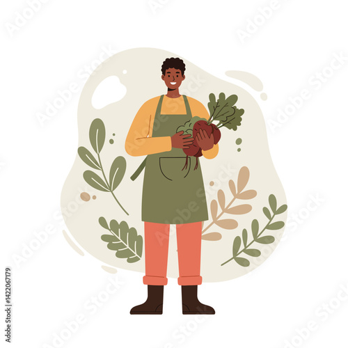 Smiling gardener holding freshly harvested beetroot with green leaves in apron and boots with natural background of leaves and plants 