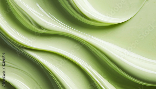 smooth light green mass with a wavy texture. The surface looks glossy and dense, resembling cosmetic cream, gel or thick paint