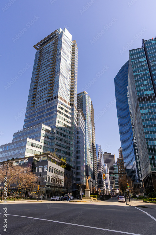 Modern Skyscrapers in Downtown Vancouver, BC, Under a Clear Blue Sky Modern Skyscrapers in Downtown Vancouver, BC, Under a Clear Blue Sky