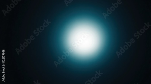 Centralized, diffused light source against a dark background.