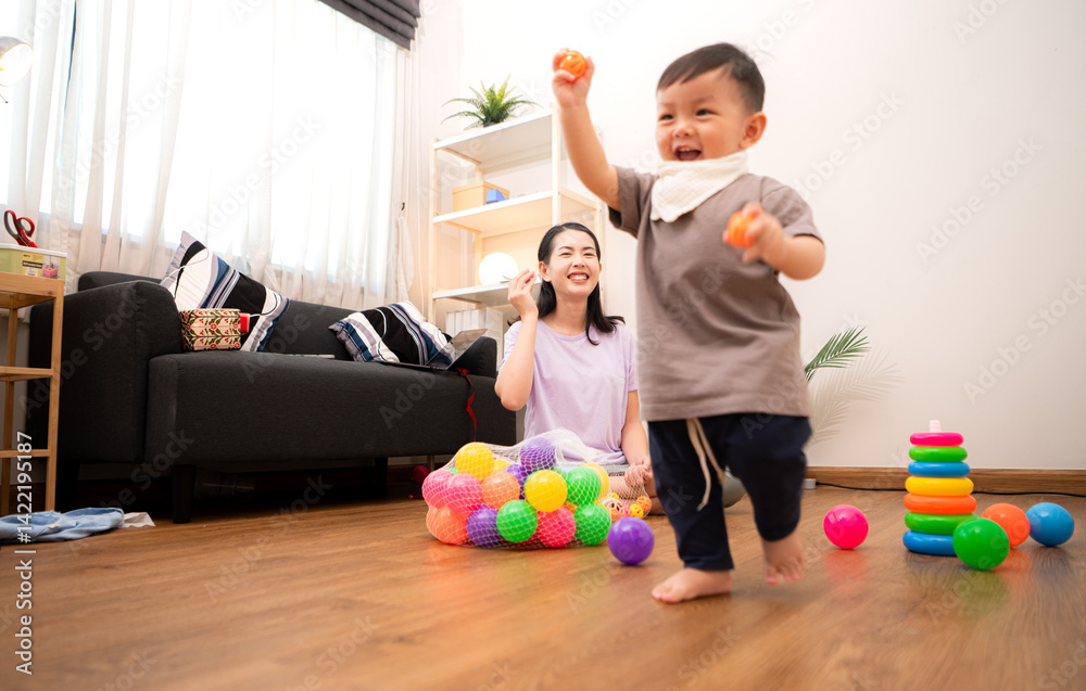 Fototapeta premium While in vacation at home, a mother engages in activities with little kid