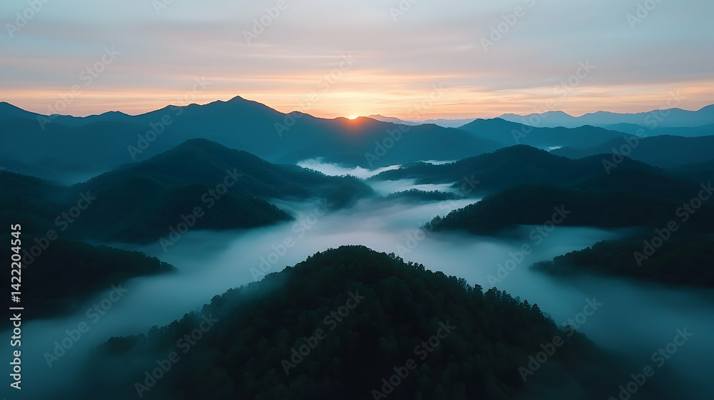 Obraz premium Misty Sunrise Over Rolling Hills and Mountains