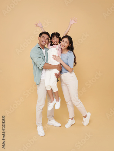 Full length Portrait happy smiling Asian family hugging and love together isolated on nude color background.
