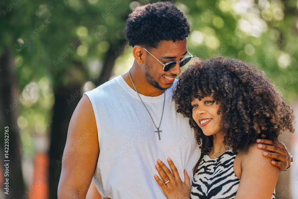 romantic latin couple hugging happily outdoors
