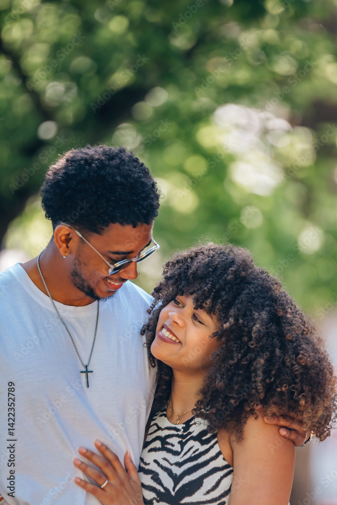 romantic latin couple hugging happily outdoors