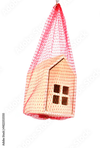 Model house suspended in a red mesh safety net. No people.  Mortgage arrears safety net concept.
