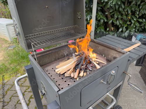 barbecue grill with fire in the garden