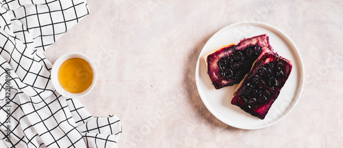 Delicious upside down berry pies on a plate on the table top view web banner