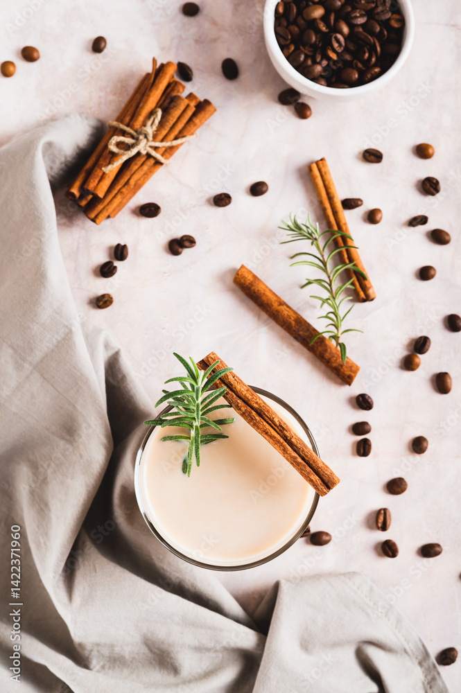 Cup of iced latte with rosemary and cinnamon on the table top and vertical view