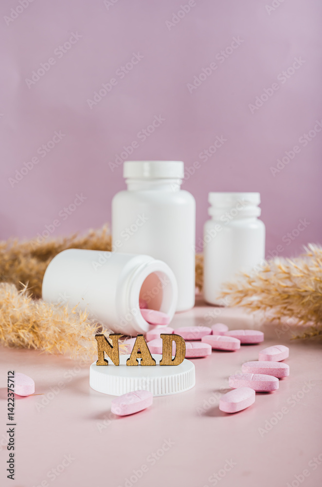 Nicotinamide adenine dinucleotide anti-aging pills and bottles on the table vertical view