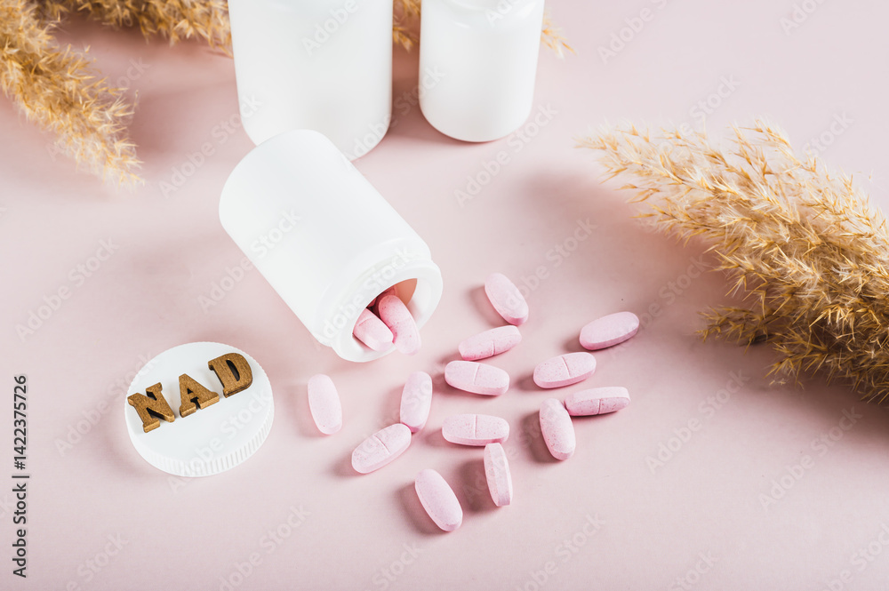 NAD+ molecule in pills for anti-aging and biohacking on pink background