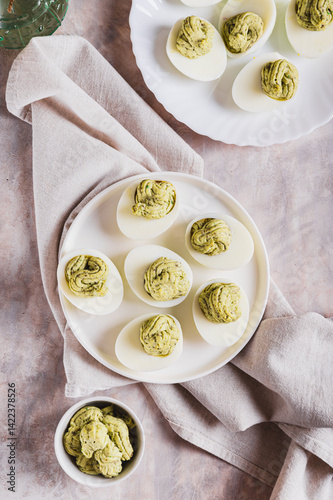 Obraz na płótnie Avocado deviled eggs for appetizer on plate on table top and vertical view w salonie
