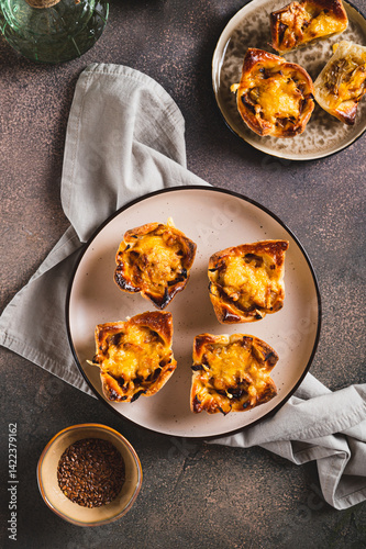Obraz na płótnie Homemade caramelized onion savory pies on a plate on the table top and vertical view w salonie