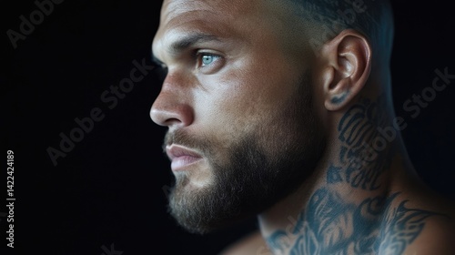 Close-up profile of man with tattoo