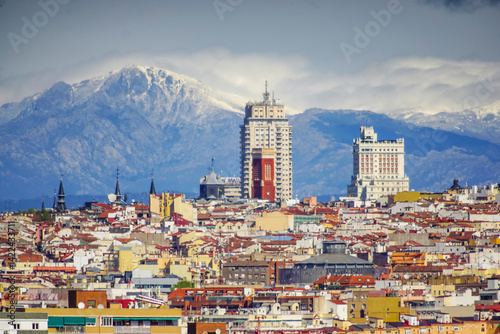 Panoramic view of Madrid, the capital of Spain, with the partially snow-covered mountains in the background.
