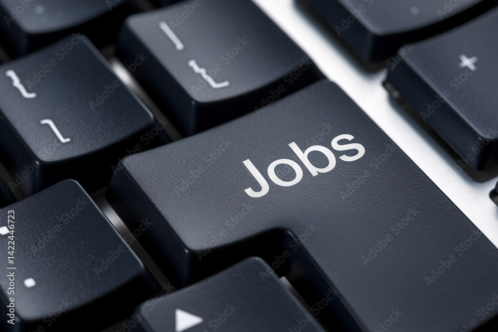 Close-up of dark gray keyboard key with word Jobs, showcasing textured surface, representing online job search, employment, and career opportunities Close-up of dark gray keyboard key with word Jobs, showcasing textured surface, representing online job search, employment, and career opportunities