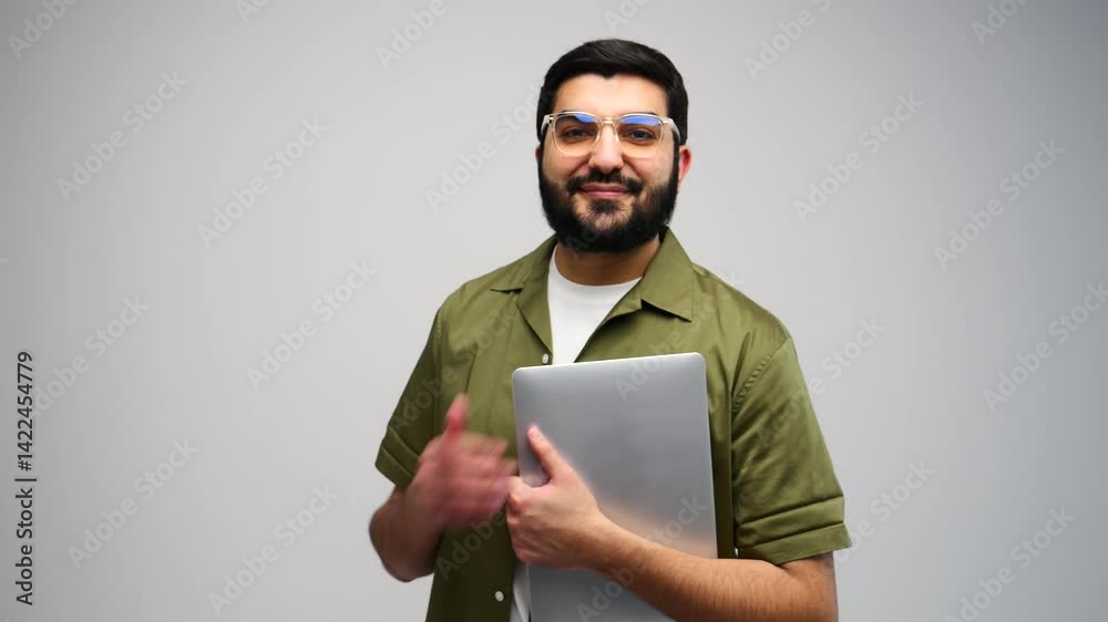 Young Man Engaged With Laptop in a Minimalist Studio, Showcasing Focus and Determination While Working Creatively Young Man Engaged With Laptop in a Minimalist Studio, Showcasing Focus and Determination While Working Creatively