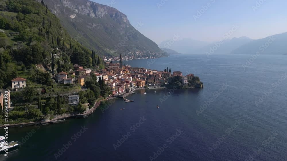 Aerial orbit view of Varenna during sunny afternoon from far, famous picturesque old town and turistic destination in Lake Como, Lombardy, Italy. Cinematic 4K drone shot. Aerial orbit view of Varenna during sunny afternoon from far, famous picturesque old town and turistic destination in Lake Como, Lombardy, Italy. Cinematic 4K drone shot.