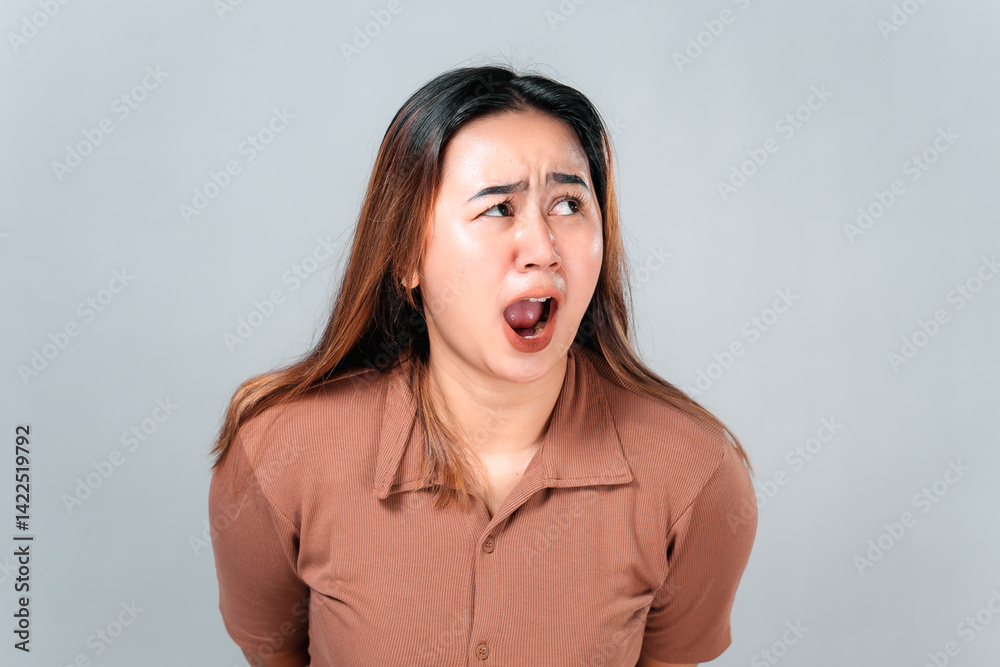 Shocked young Asian woman with wide open mouth and raised eyebrows, expressing intense surprise and fear. Her emotional reaction is perfect for dramatic, comedic, or reaction-based content. Shocked young Asian woman with wide open mouth and raised eyebrows, expressing intense surprise and fear. Her emotional reaction is perfect for dramatic, comedic, or reaction-based content.