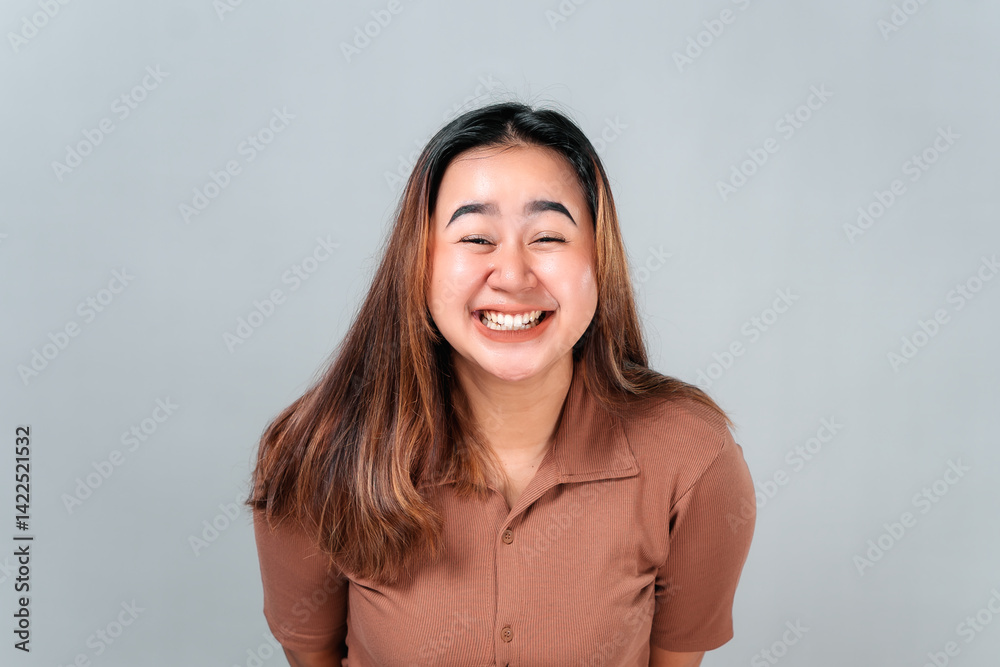 Cheerful young Asian woman smiling brightly with eyes nearly closed, showing teeth and genuine happiness. A joyful facial expression captured in a candid, close-up portrait moment. Cheerful young Asian woman smiling brightly with eyes nearly closed, showing teeth and genuine happiness. A joyful facial expression captured in a candid, close-up portrait moment.