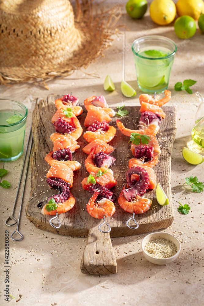 Preparation of spicy grilled skewer served with coriander and lime.