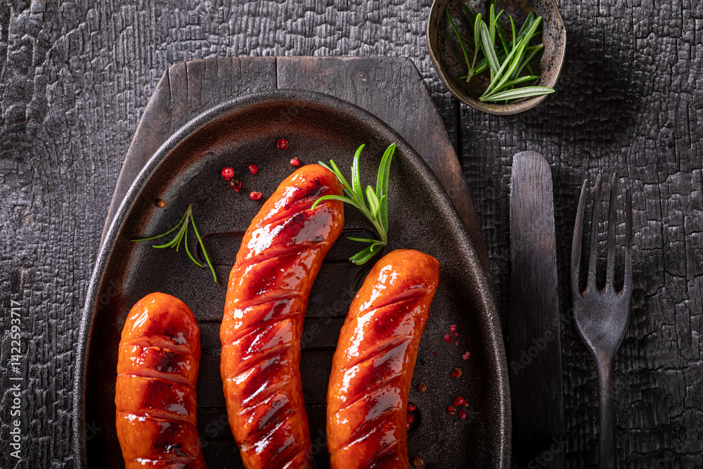 Delicious grilled sausage with mustard sauce and rosemary.