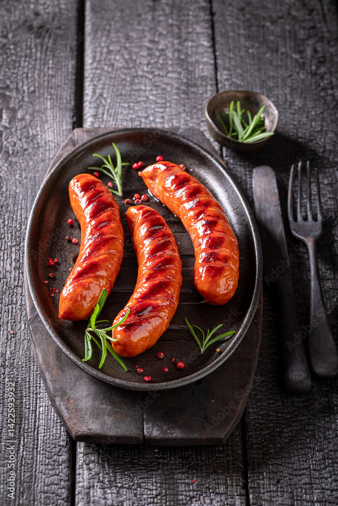 Hot roasted sausage made on a metal grill.