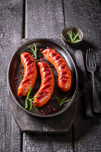 Hot roasted sausage made on a metal grill.