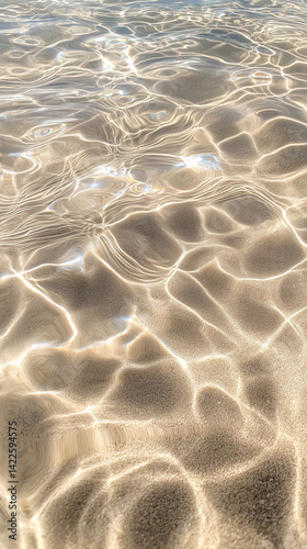Sunlight dancing on clear water at a serene beach during the afternoon
