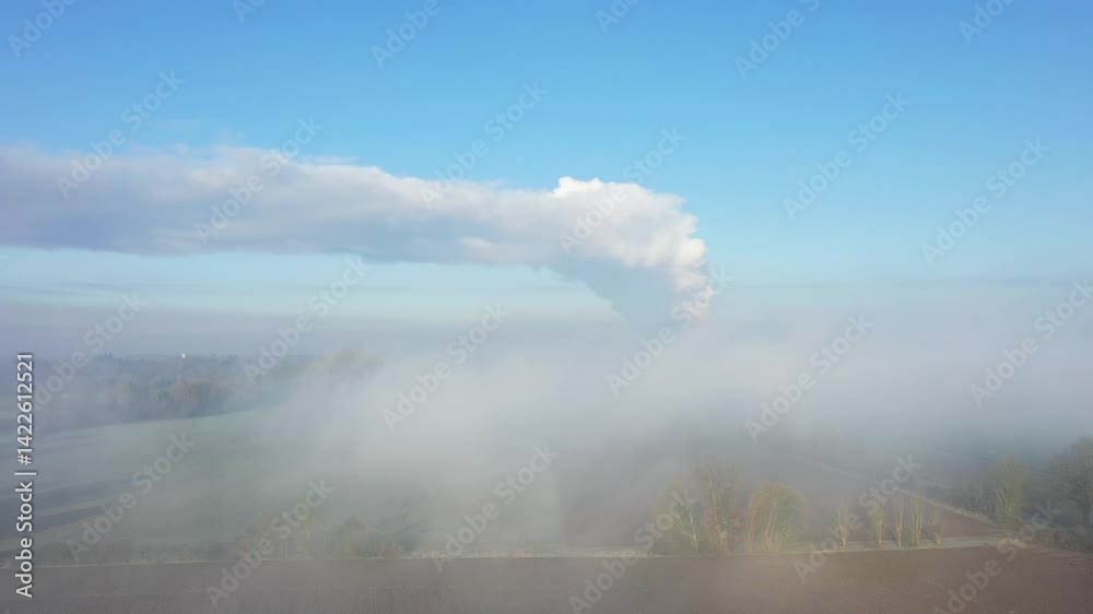 The Dampierre power station shrouded in mist in Europe, France, in the Centre region, in Loiret, near Orleans, in winter, on a sunny day. The Dampierre power station shrouded in mist in Europe, France, in the Centre region, in Loiret, near Orleans, in winter, on a sunny day.
