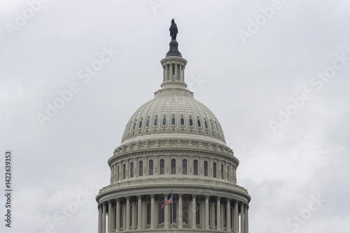 The United States Capitol dome against a cloudy sky viewed from the east front of the U.S. Capitol building in Washington, DC.