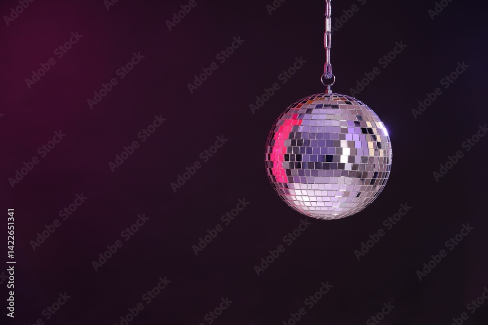 Obraz premium Shiny disco ball on dark purple background, space for text