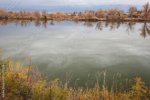 gravel pit converted into natural area - Riverbend Ponds, Fort Collins, Colorado in late fall scenery with residential homes in background photo