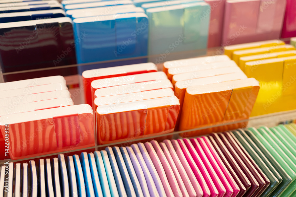 Colorful stationery display assorted notebooks. Colorful notebooks on store shelf.