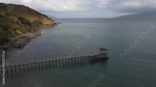 Wallpaper Mural Aerial footage of harbor in Golo Mori Island beach with long bridge dock and sailing boats around. Torontodigital.ca