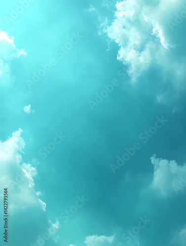 Teal sky with fluffy white clouds.