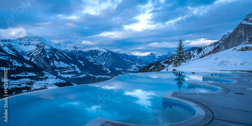 Luxury winter resort with infinity pool and snow mountain views in swiss alps for travel and tourism