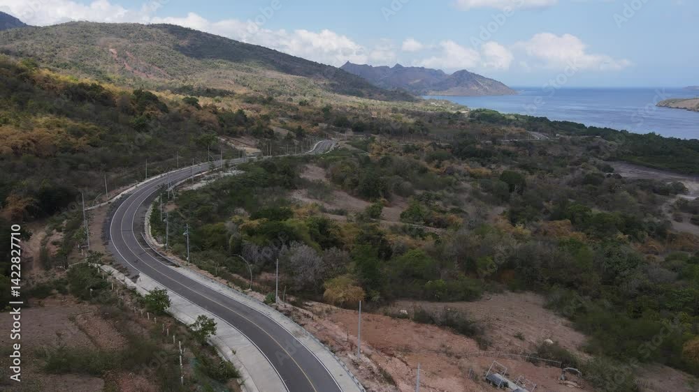 Aerial drone view of the road in Golomori island mountain peak in Labuan Bajo, Indonesia. Aerial drone view of the road in Golomori island mountain peak in Labuan Bajo, Indonesia.
