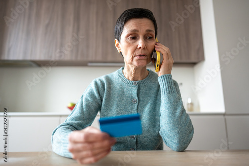 Scared nervous woman transferring money to scammers over phone. Fraud deception, bank card information theft, manipulation identity theft, financial crime, personal data exposure, vulnerable scam