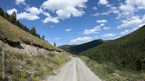 Hyperlapse video of driving on off-road car along a mountain forest road. Yazula mountain pass in Altai.