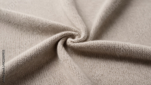 An elegant curl of knitted fabric. An organic background of natural woolen fabric.
