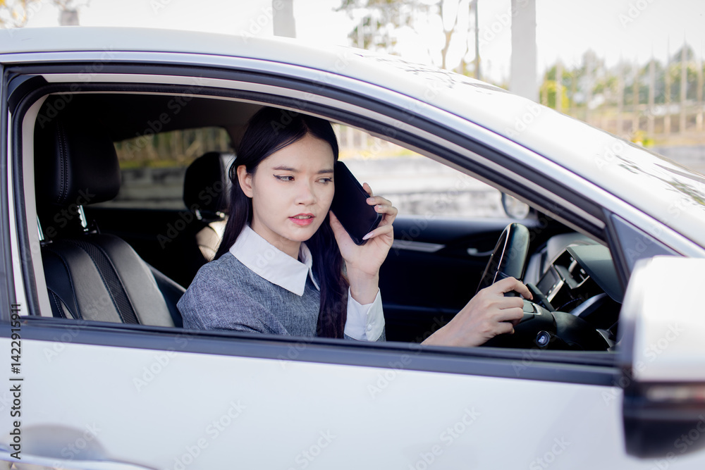 A woman is talking on the phone while driving. A woman is talking on the phone while driving.
