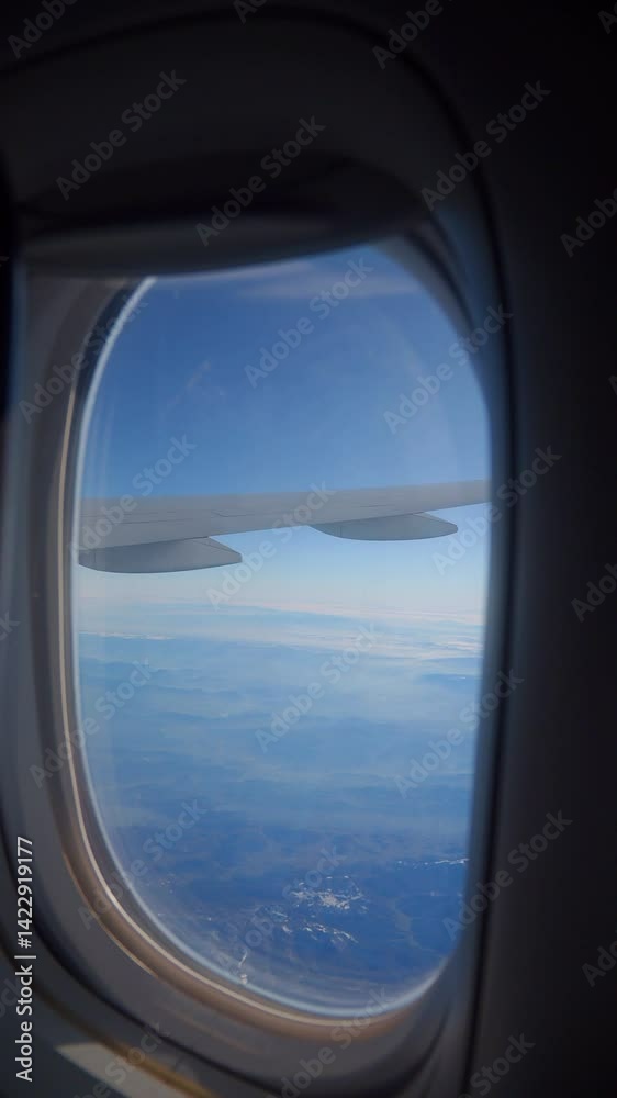 Clear view from airplane window during daytime flight Clear view from airplane window during daytime flight