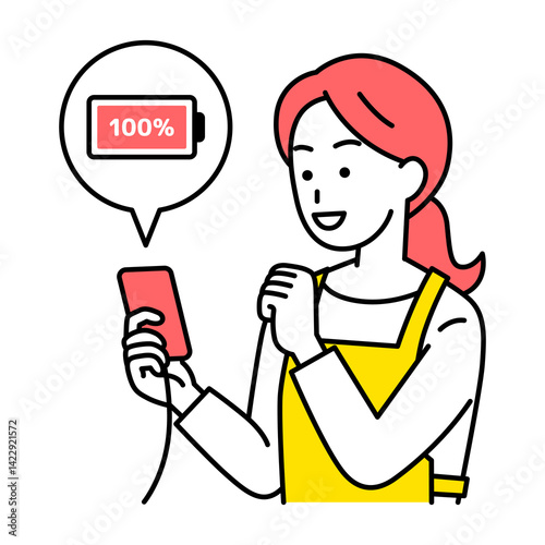 スマートフォンを充電するエプロン姿の女性