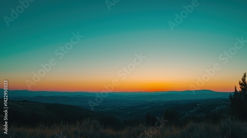 A serene sunset with a clear sky, vibrant colors fading into the horizon.