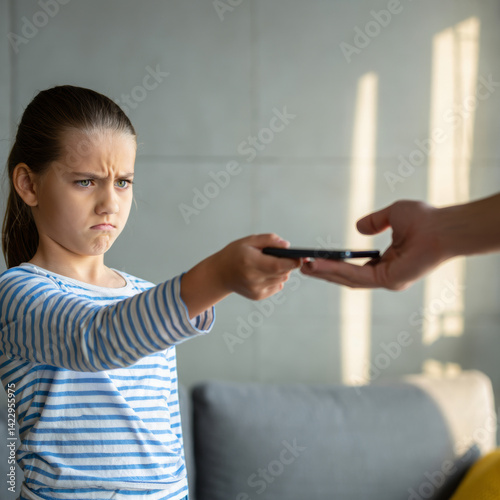 Angry child reluctantly handing over smartphone to parent – screen time conflict and digital detox parenting concept