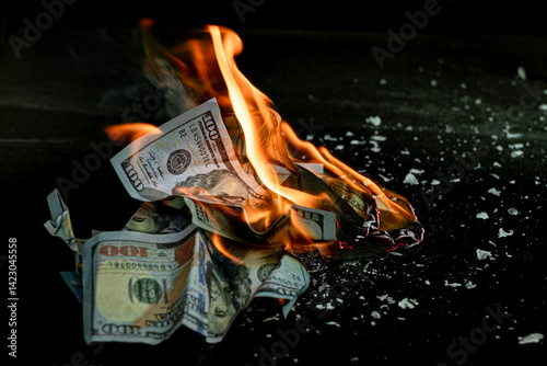 Stack banknote is burning on a black background