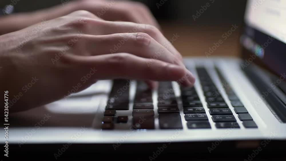 Close-up of male hands typing on a laptop keyboard Close-up of male hands typing on a laptop keyboard