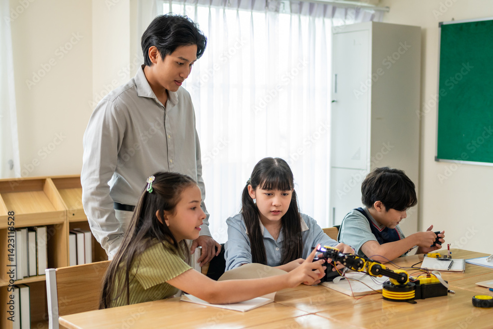 Group of students learning in a robotics class at elementary school. Group of students learning in a robotics class at elementary school.